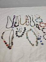 Full layout of all necklaces, bracelets and earrings on white background