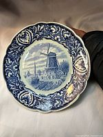 Front view of Delft Blue plate showing full design and scalloped edge