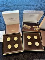 Full lot: two boxes of button covers, cufflinks in case, packaging visible