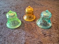 Front view of three colored glass Liberty Bells