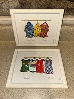 Both framed prints side by side