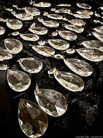 Group of teardrop prisms spread on black fabric