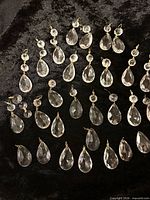 Group view of all 31 glass teardrop prisms with button tops