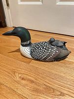 Full profile of carved loon with chick showing overall form and paint