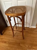 Stool full view showing bentwood frame, footrest, overall condition