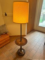 Full view of floor lamp with table and shade