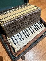 Accordion in case showing keys and grill