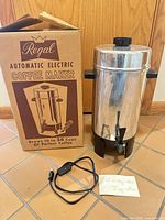 Full view of coffee urn with box and power cord