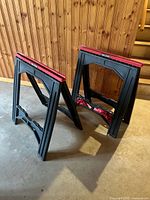 Pair of black Task Force folding sawhorses standing on concrete floor