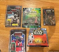 Five sealed Star Wars items laid out on floor