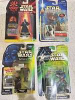 All four sealed Star Wars action figures on floor