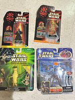 All four sealed Star Wars action figures displayed on floor