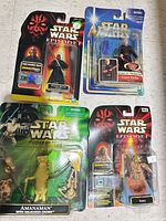 Group shot of four sealed Star Wars action figures on cards