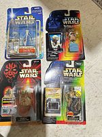 Group shot of all four sealed Star Wars figures on cards
