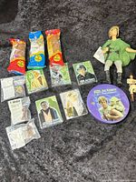 Group shot of all items: PEZ dispensers, trading cards, collector tin, action figures, miniature figures