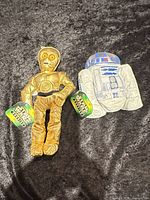 Front view of C-3PO and R2-D2 plush with tags
