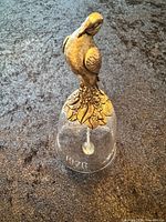 Full view of bell showing sterling dove handle and crystal body