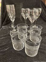 All nine clear glass pieces grouped on black fabric