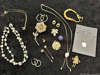 All jewelry pieces laid out on black background
