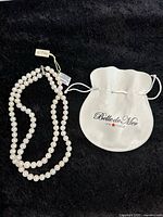 Full view of double strand pearl necklace with Belle de Mer pouch