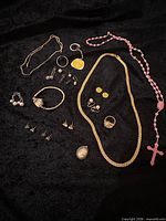 Overview of all jewelry pieces laid out on black fabric