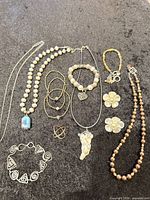All jewelry pieces laid out on black surface