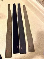 Four knit ties laid flat showcasing color range and squared ends