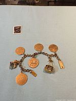 Full view of yellow gold charm bracelet with all charms visible