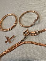 All four jewelry pieces laid out showing overall form