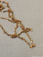 Close-up of gold rectangular box link chain