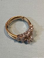 Both rings side by side showing yellow gold shanks and diamond clusters