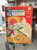 Front cover of All-American Comics #90 showing title banner, price, page count and Icicle introduction blurb