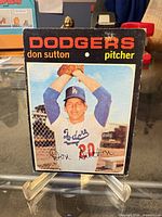 Front of Don Sutton Topps baseball card showing photo, team name and signature