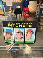 Front of card showing three player images and title text