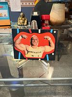 Front of 1985 WWF Hulk Hogan sticker card on stand