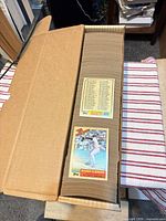 Long cardboard storage box filled edge-to-edge with tightly packed 1987 Topps cards; Roger Clemens and checklist card on top