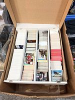 Top view of open storage box showing three rows filled with hockey cards