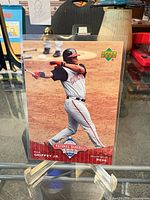 Front view of Ken Griffey Jr. card in protective sleeve on stand