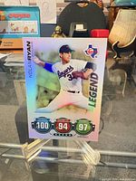 Front view of 2010 Topps Attax Nolan Ryan holographic card on stand