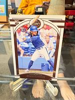 Front view of 2020 Panini Chronicles Legacy Bo Bichette rookie card on display stand