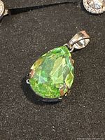 Front view showing green faceted teardrop stone set in sterling silver