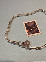 Bracelet close-up showing lobster clasp, 925 tag and snake chain links