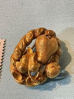 Front view showing pear and leaf design within twisted border