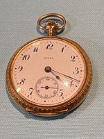 Front view of Birks pocket watch showing dial and hands