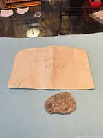 Envelope labelled "Our piece of the Berlin Wall" with concrete fragment below