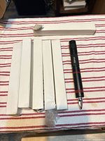 Five boxed units, one loose black aluminum tool showing full length