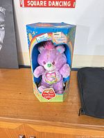 Front view of Love-A-Lot Bear plush in original box