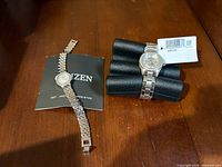 Overview of both Citizen watches and booklet