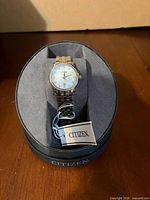 Front view of Citizen wristwatch in box with tag visible