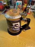 Full view of stein with lid, handle and tag visible